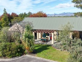 A house with a patio and outdoor furniture at Vintners - Renwick Holiday Home, Blenheim