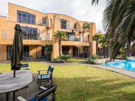 An outdoor area with a building, garden, and swimming pool at La Belle Retreat - Ruakaka