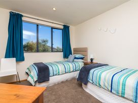 A bedroom with two beds and a window at La Belle Retreat - Ruakaka Holiday Apartment Ruakaka