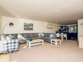 A living room with a sofa and coffee table at La Belle Retreat - Ruakaka Holiday Apartment Ruakaka