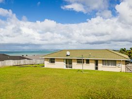 A house with a satellite dish and clothesline at Bay Heights Bach - Bay Of Islands Retreat, Kaitaia