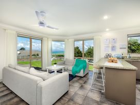 A living room with a sofa and coffee table at Bay Heights Bach - Bay Of Islands Retreat Kaitaia