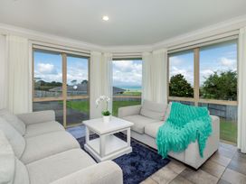 A living room with a sofa and coffee table at Bay Heights Bach - Bay Of Islands Retreat Kaitaia