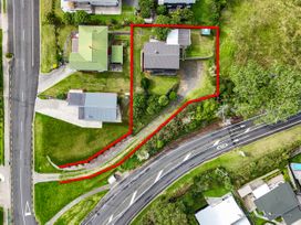 An aerial view of a property with houses and surrounding garden at Raglan Holiday Home in Raglan