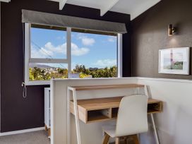 An office with a desk and chair by a window at Raglan Holiday Home in Raglan