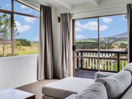 A living room with a view and a sofa at Raglan Holiday Home in Raglan