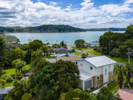 A view of houses and water at Raglan Holiday Home in Raglan