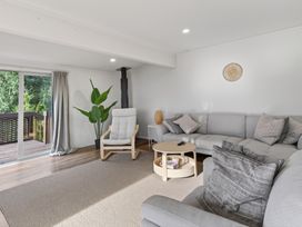 A living room with a couch and coffee table at Sundowners - Mangawhai Heads Holiday Home, Mangawhai