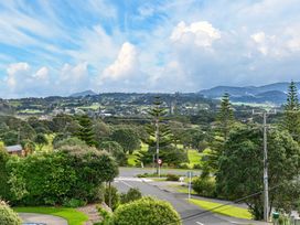 A landscape view with trees and a road at Sundowners - Mangawhai Heads Holiday Home, Mangawhai