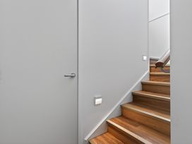 A stairway leading to an upper floor at Sundowners - Mangawhai Heads Holiday Home Mangawhai