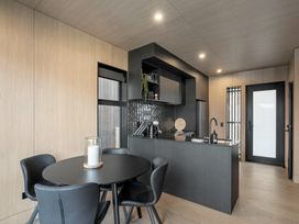 A kitchen with a table and chairs at Stonepeak - Queenstown Holiday Home in Queenstown