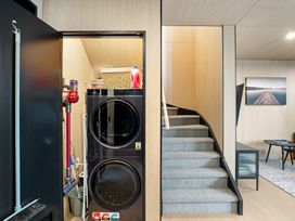 A laundry room with washing machine and dryer at Stonepeak - Queenstown Holiday Home in Queenstown