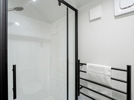 A shower with a towel rack in a bathroom at Stonepeak - Queenstown Holiday Home in Queenstown