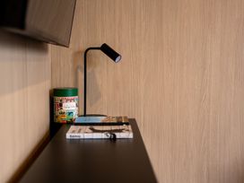 A shelf with books and a lamp at Stonepeak - Queenstown Holiday Home in Queenstown