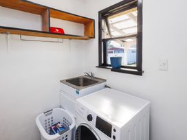 A laundry room with a washing machine and dryer at Dannevirke Lodge - Dannevirke