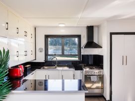 A kitchen with a sink and stove at Dannevirke Lodge - Dannevirke