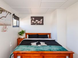 A bedroom with a bed and plant at Dannevirke Lodge - Dannevirke