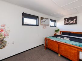 A bedroom with a bed and decor at Dannevirke Lodge - Dannevirke
