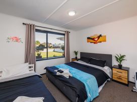 A bedroom with two beds and a window at Dannevirke Lodge - Dannevirke