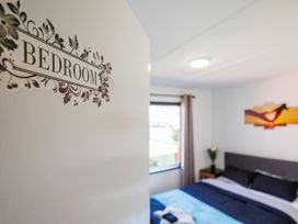 A bedroom with a bed and window at Dannevirke Lodge - Dannevirke
