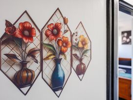 A wall art featuring flower arrangements in vases at Dannevirke Lodge - Dannevirke