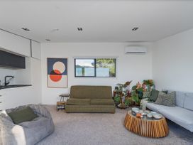 A living room with a sofa and coffee table at Little Tui Ridge - Coromandel Holiday Home in Coromandel