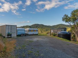 A scene with caravans and a shipping container in an outdoor area at Little Tui Ridge - Coromandel