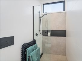 A shower area with towels and shower items at Little Tui Ridge - Coromandel