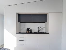 A kitchen with a sink and kettle at Little Tui Ridge - Coromandel Holiday Home in Coromandel