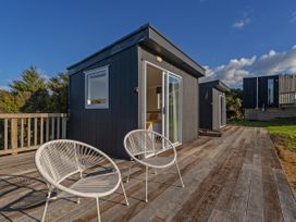 An outdoor area with chairs and a view at Little Tui Ridge - Coromandel Holiday Home, Coromandel