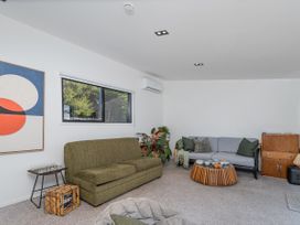 A living room with a sofa and coffee table at Little Tui Ridge - Coromandel