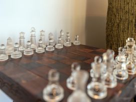 A chess set on a wooden board at Little Tui Ridge - Coromandel Holiday Home, Coromandel