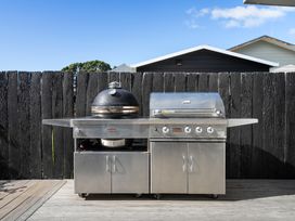 An outdoor kitchen featuring a grill and smoker at The Wallnutt Grove - Waihi Beach