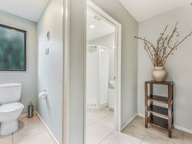 A bathroom with a toilet and shower at Vineyard View - Blenheim Holiday Home