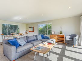 A living room with a sofa and coffee table at Vineyard View - Blenheim Holiday Home in Blenheim