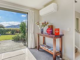 A hallway with a table and flowers at Vineyard View - Blenheim Holiday Home Blenheim