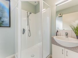 A bathroom with a shower and sink at Vineyard View - Blenheim Holiday Home