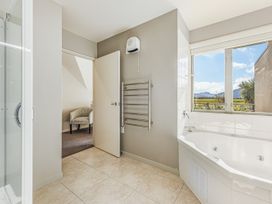 A bathroom with a bathtub and shower at Vineyard View - Blenheim Holiday Home