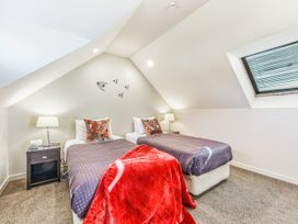 A bedroom with two beds and a window at Vineyard View - Blenheim Holiday Home in Blenheim