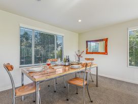 A dining room with a table set for a meal at Vineyard View - Blenheim Holiday Home in Blenheim