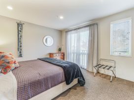 A bedroom with a bed and a dresser at Vineyard View - Blenheim Holiday Home