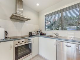 A kitchen with stove, oven, and sink at Vineyard View - Blenheim Holiday Home