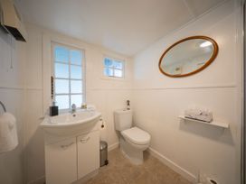 A bathroom with a sink and toilet at Dragon Fly Cottage - Te Anau Holiday Home Te Anau