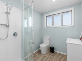 A bathroom with a shower and toilet at Get Away By The Green - Cromwell