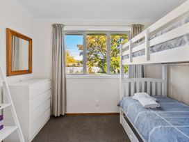 A bedroom with a bunk bed and a dresser at Get Away By The Green - Cromwell