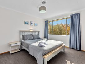 A bedroom with a bed and nightstand at Get Away By The Green - Cromwell
