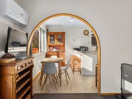 A kitchen with a dining table and chairs at Get Away By The Green - Cromwell