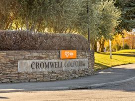 A sign for Cromwell Golf Club with surrounding greenery at Get Away By The Green - Cromwell