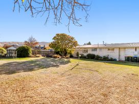 A house with a garden and trees at Get Away By The Green - Cromwell