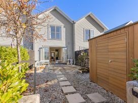 An outdoor area with a house and a pathway at Te Ohu - Wanaka Holiday Home in Wanaka